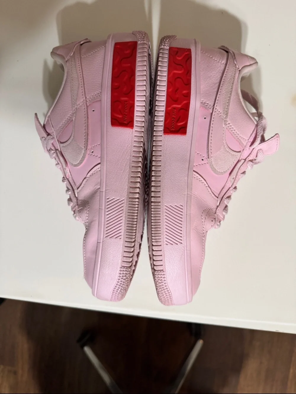 Nike Women’s Pink Low-Top Sneakers with Red Accent